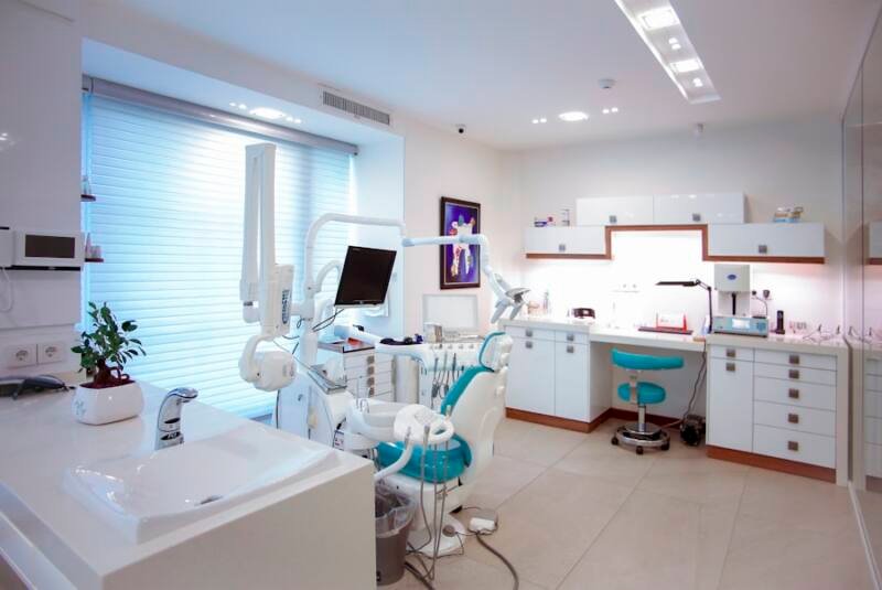 Friendly dental team reviewing new patient health history